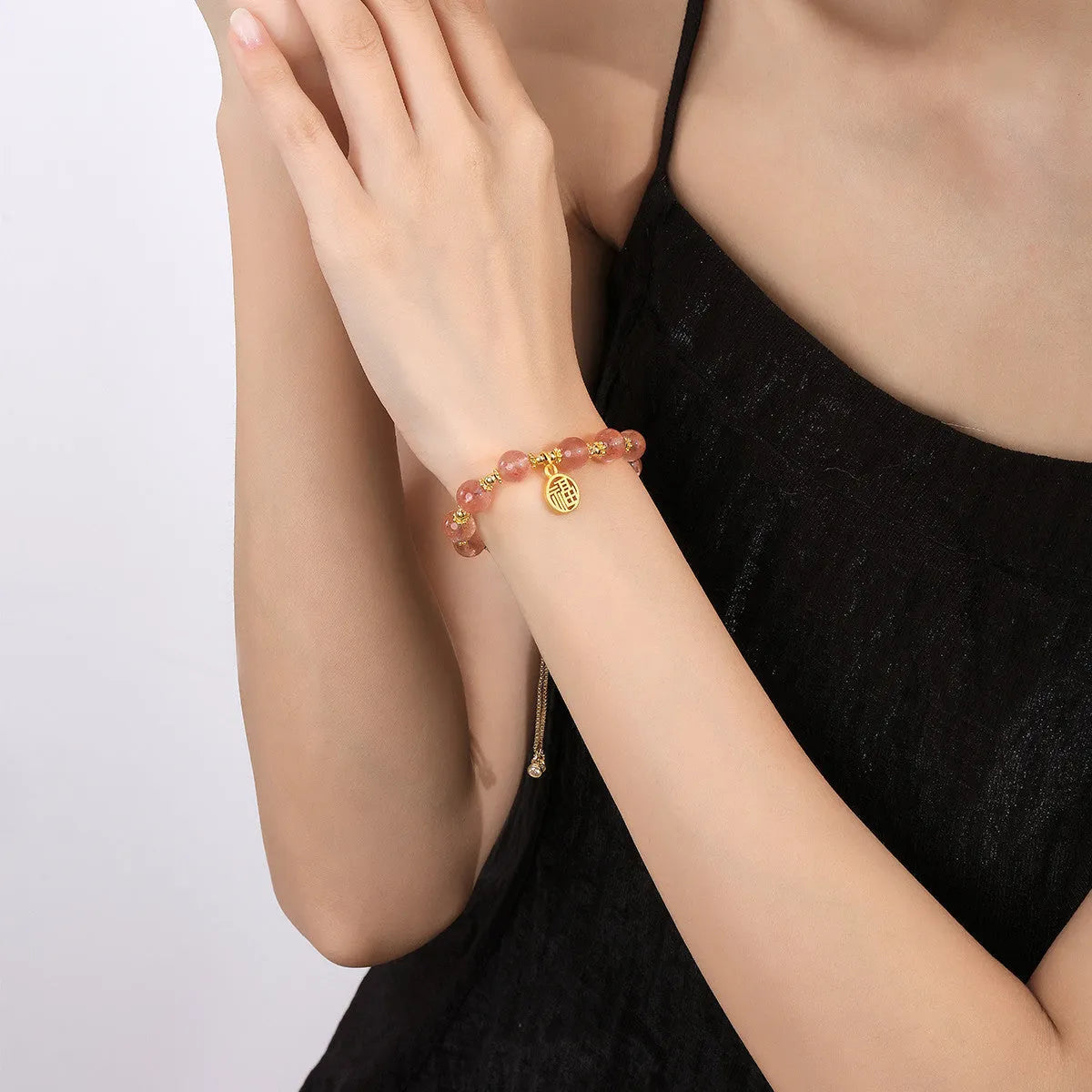 Women's strawberry quartz crystal bracelet with electroplated fu character charm and geometric design