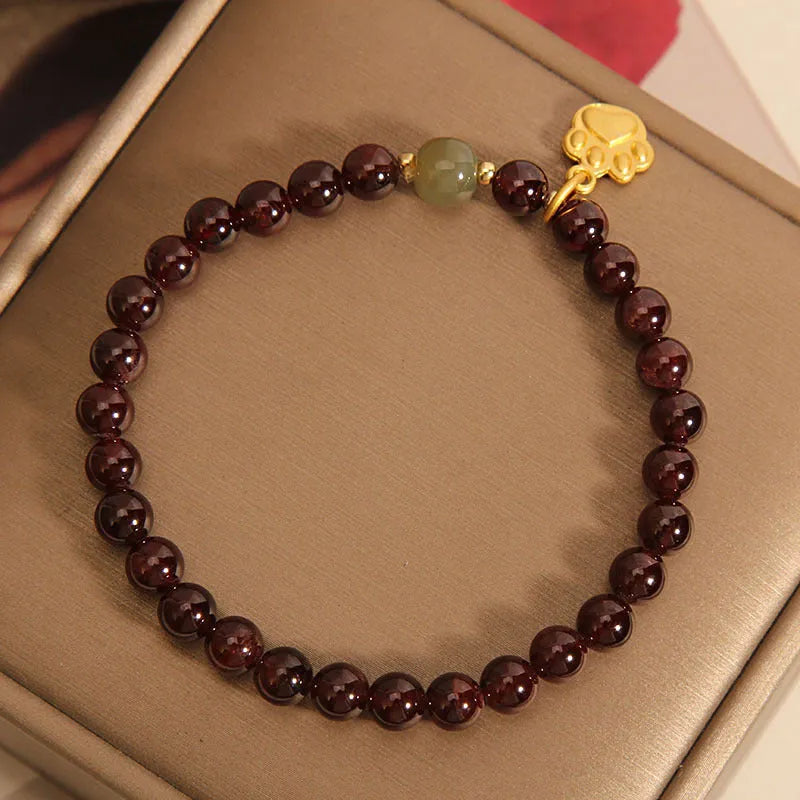 Women's Cat's Paw garnet style crystal bracelet on packaging