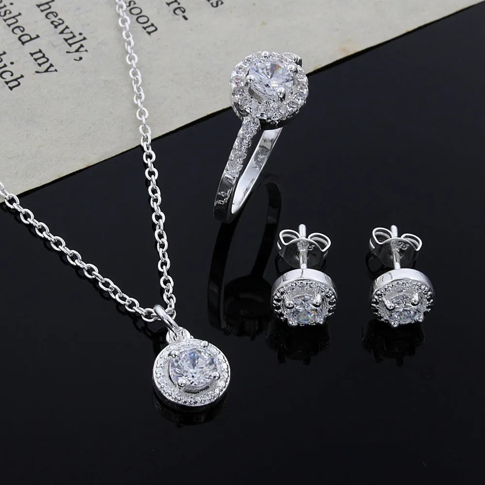 Zircon jewellery suit with inlaid apple ring and necklace silver tone on white background