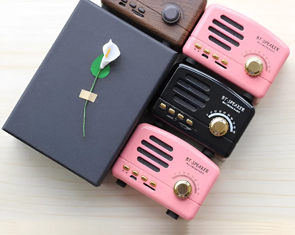 Compact vintage style wood grain Bluetooth speaker on a table next to a mobile phone.
