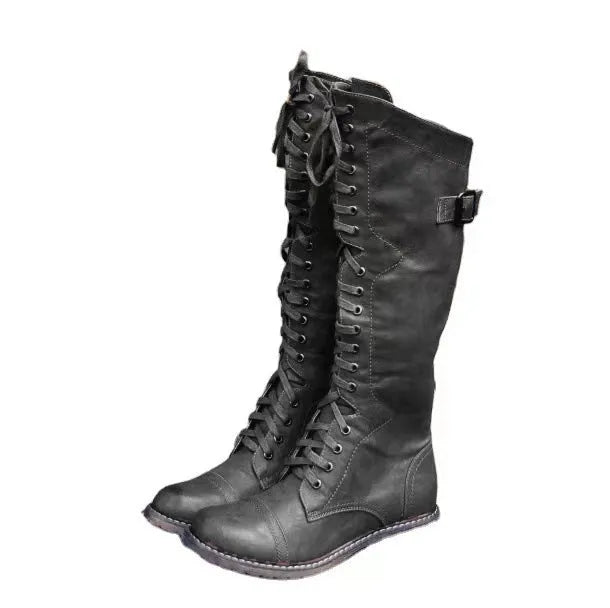 Brown high leg casual boots with a round toe and a chunky low heel on a plain background.