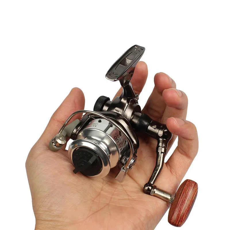 Mini 100 all metal fishing reel in black colour with folding rocker arm and wooden handle
