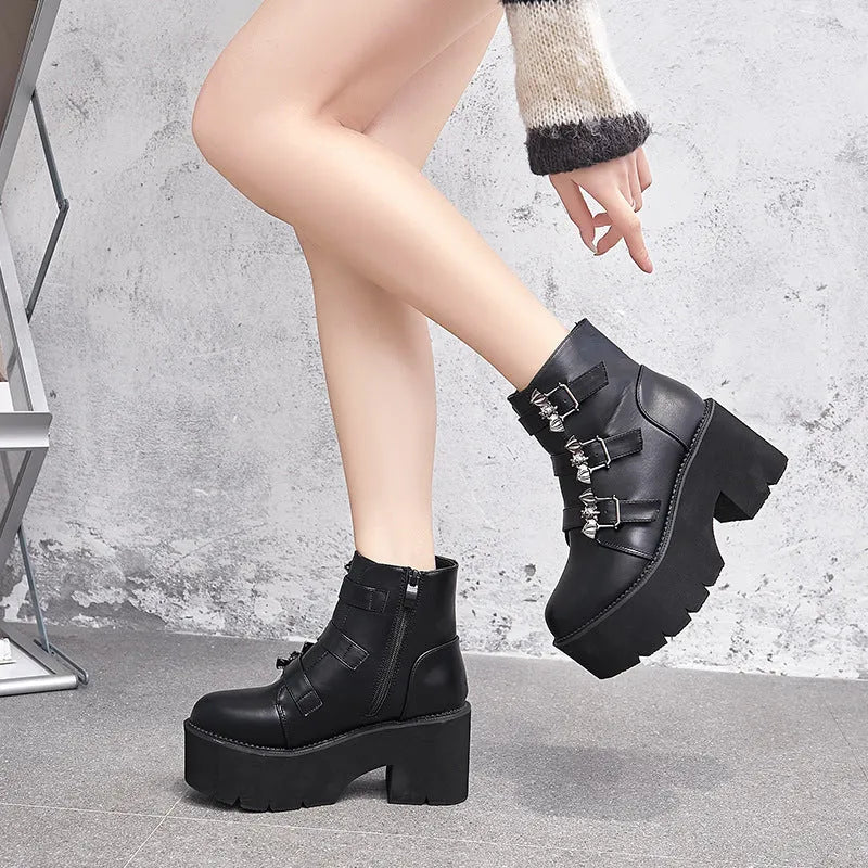 Black women's punk gothic Martin boots with bat buckle detail and side zipper.