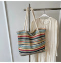 Blue woven nylon shoulder bag with single strap and straw texture.