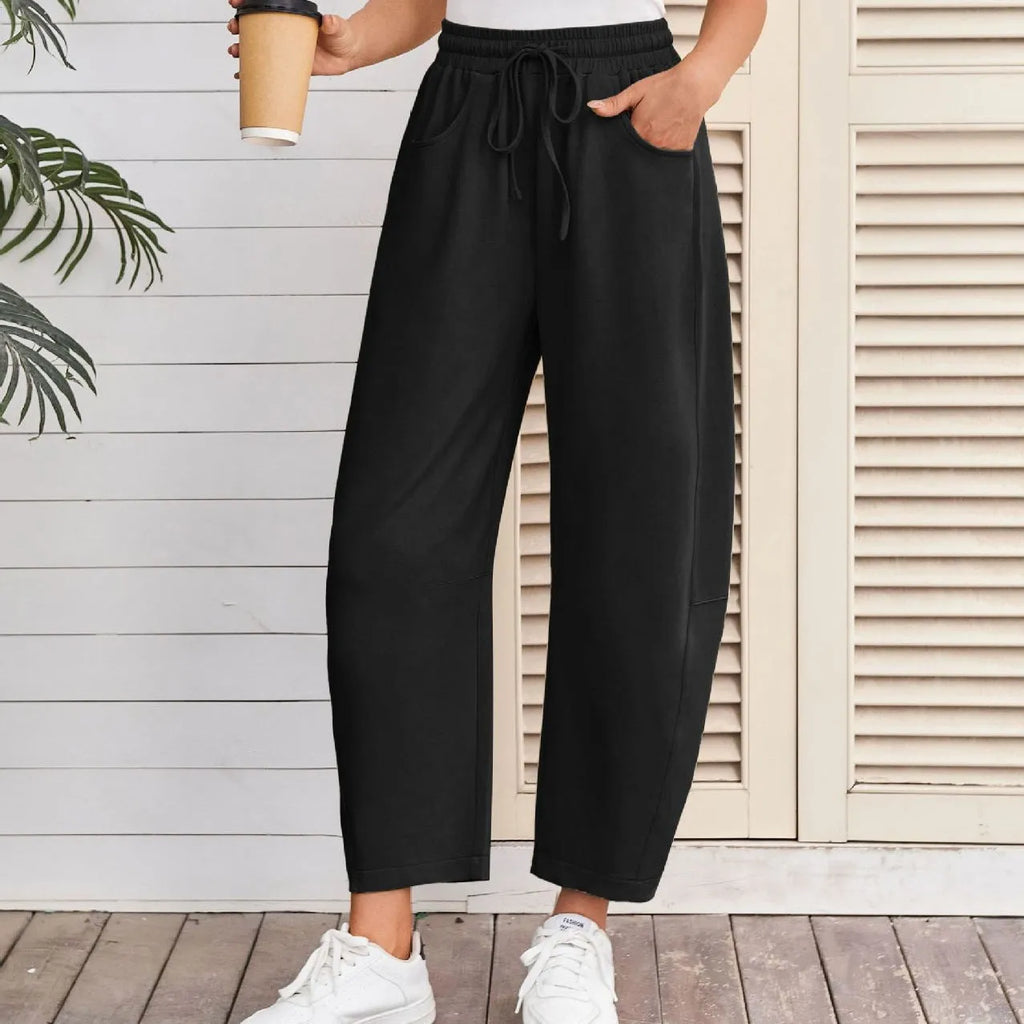 Women's loose cropped sweatpants in cotton fabric with elastic drawstring waistband in street fashion styling