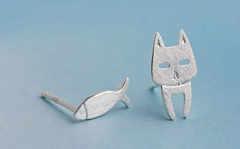 S925 sterling silver stud earrings with asymmetrical cat and fish design on white background