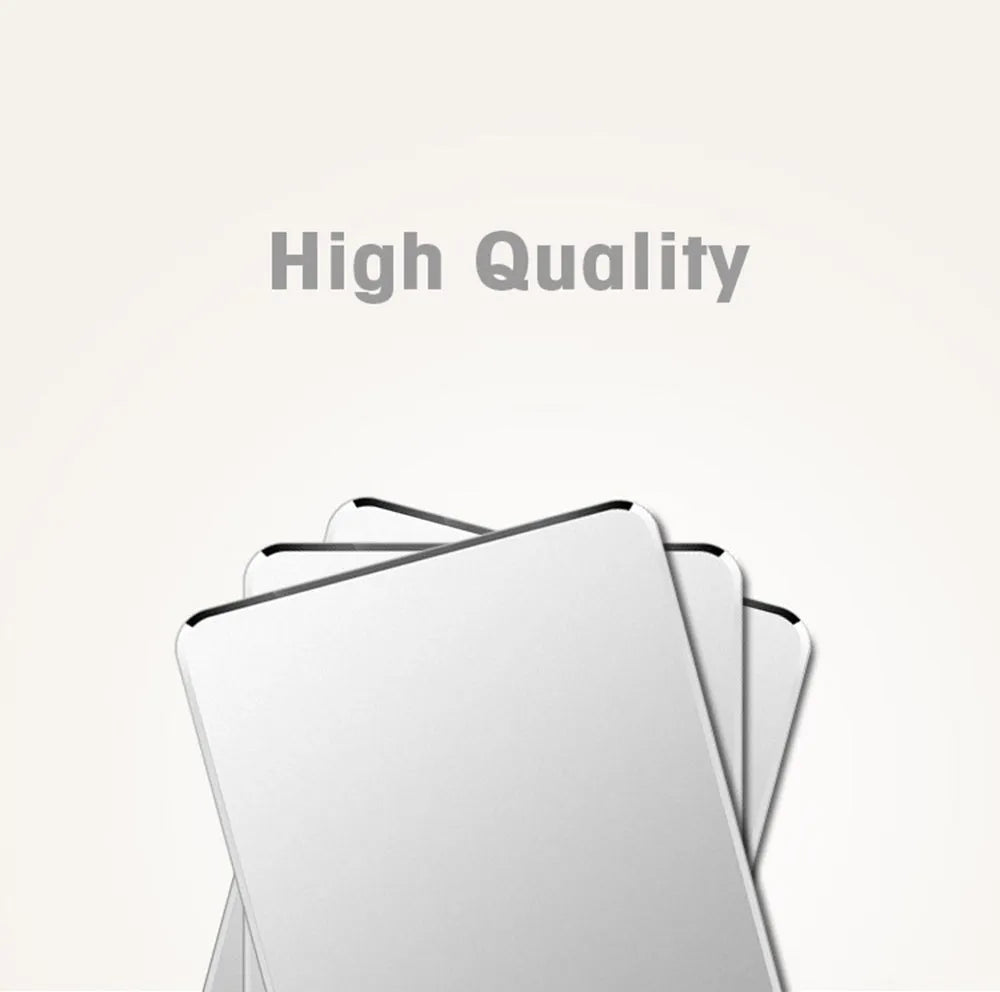 Black aluminium alloy double-sided mouse pad on a desk with a computer mouse on top