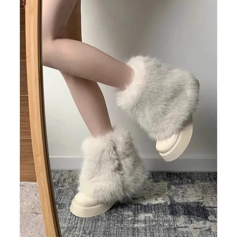 Women's black fleece-lined snow boot with a round toe and mid rubber heel on a white background.