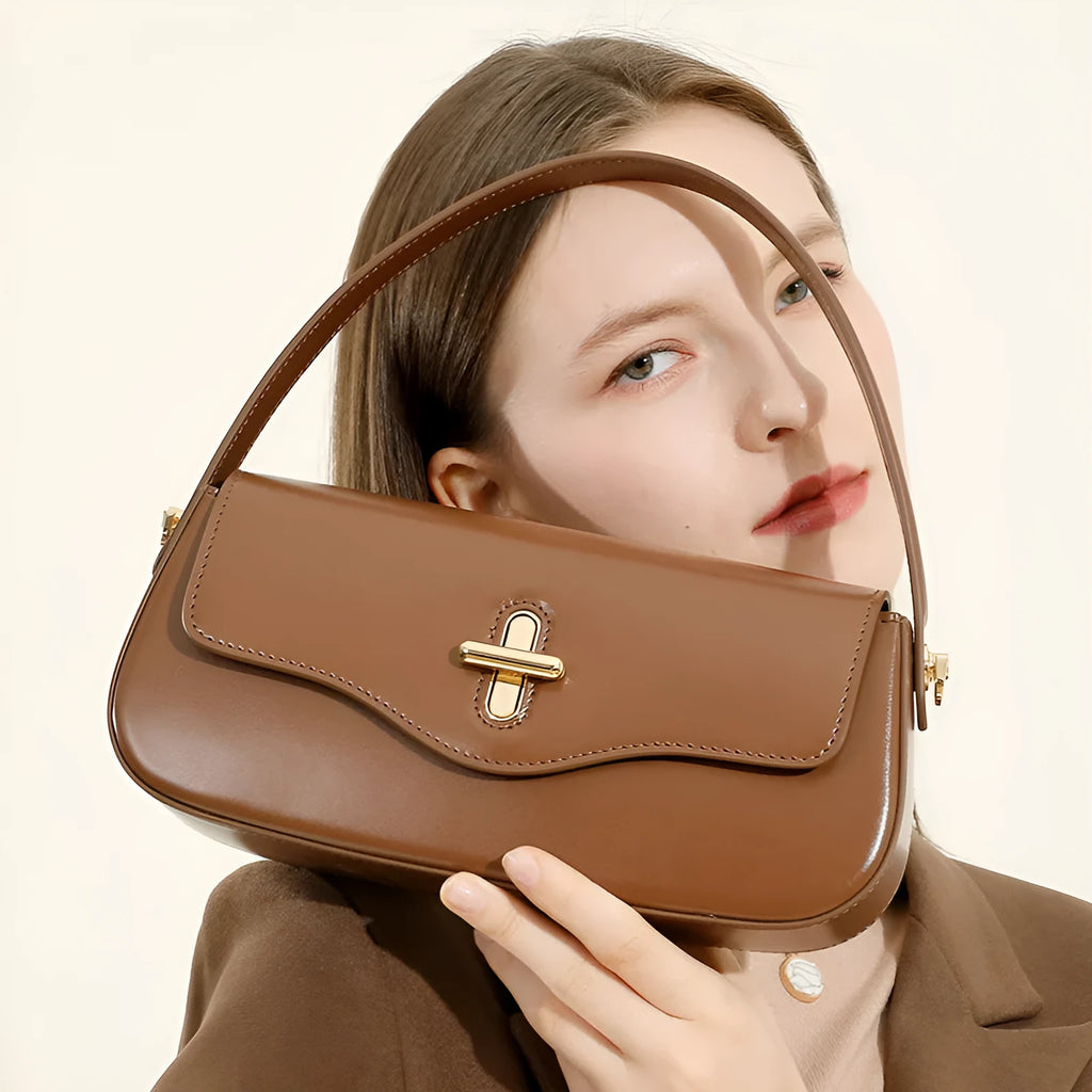 Genuine leather baguette handbag in horizontal square clamshell design, shown in black colour