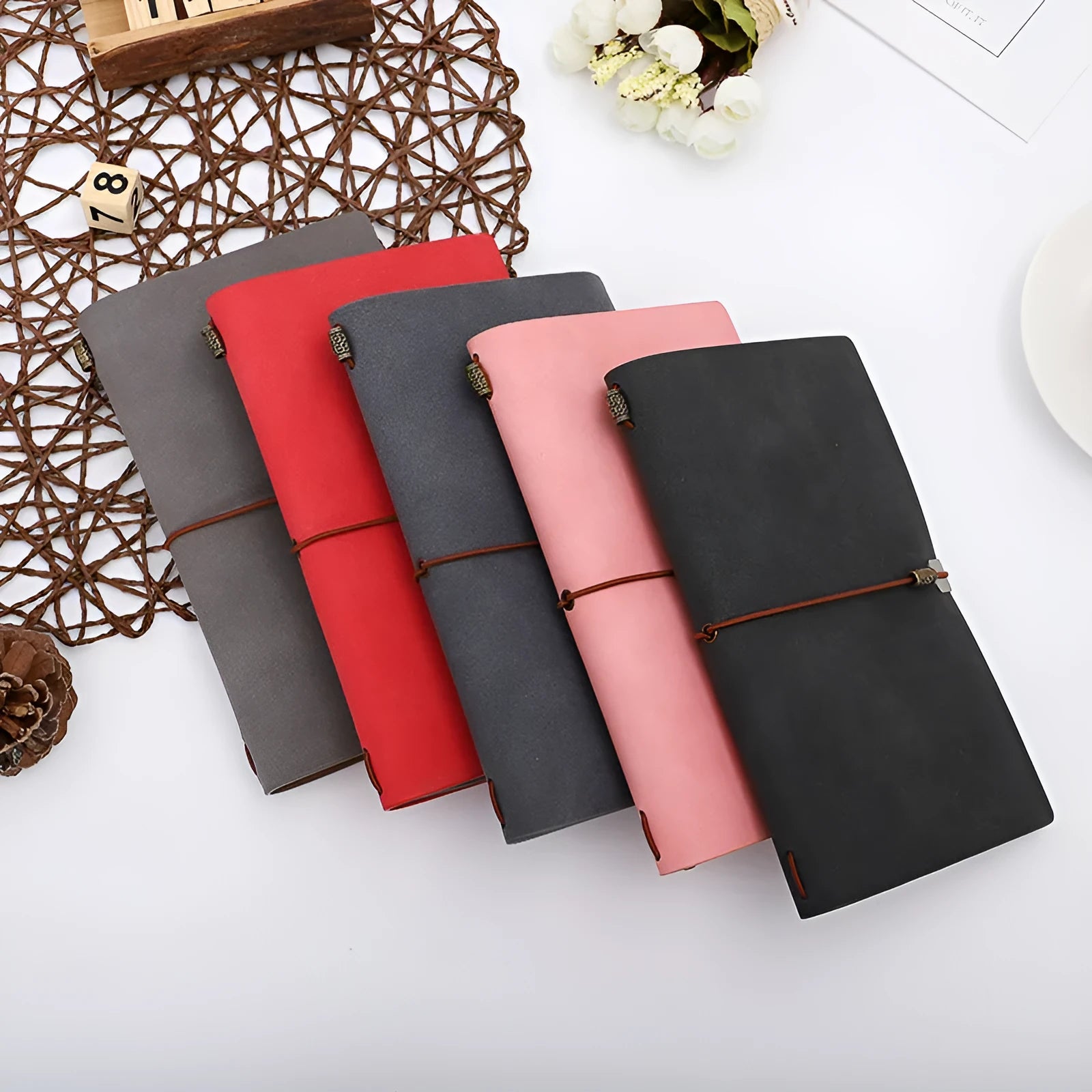 A6 diary notebook with cowhide rope design on imitation leather cover, showing wireless binding and available in grey, pink, or red colours