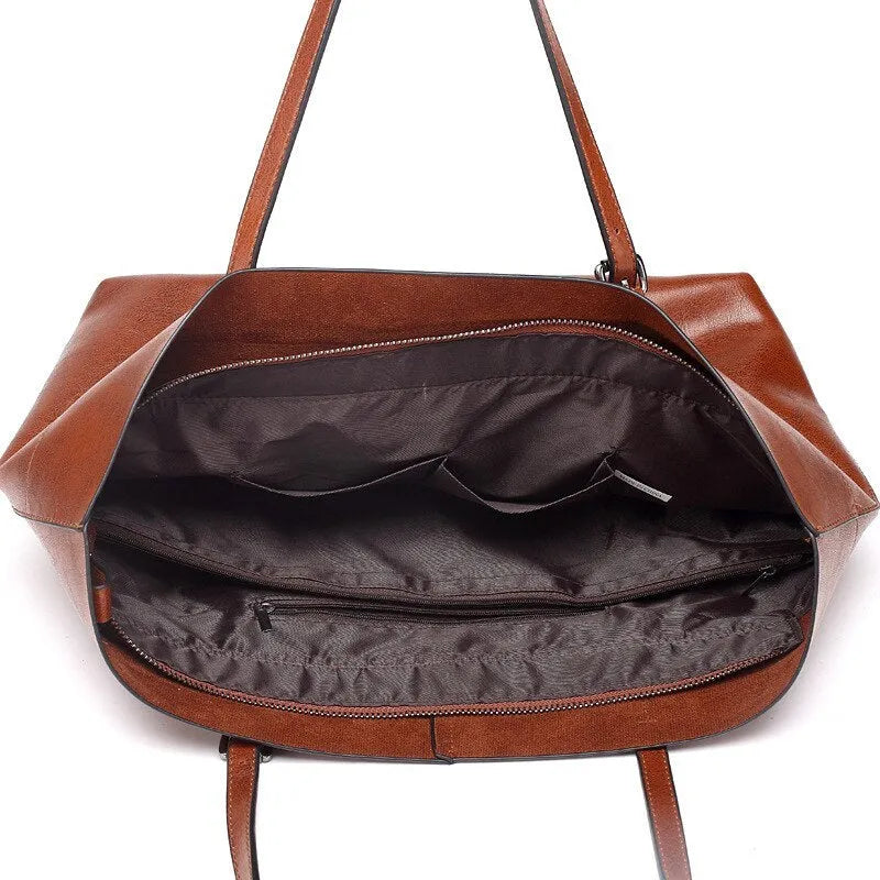 Horizontal waxed cowhide leather women's crossbody handbag showing internal phone pocket and two compartments.