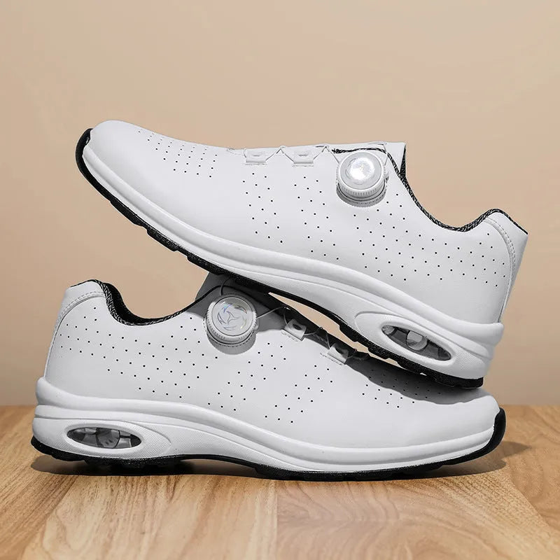 Pair of black low-top mesh tennis shoes with cross shoulder straps and white laces.