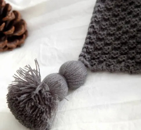Nordic style fringed knit blanket in acrylic fabric, shown in beige colour, measuring 130 by 170 centimetres.