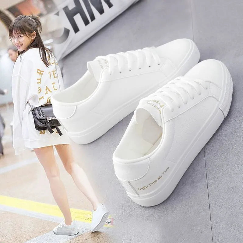 Women's white canvas sneakers with rubber sole and lace-up closure