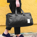 Black waterproof sports bag with separate side shoe compartments and diagonal shoulder straps