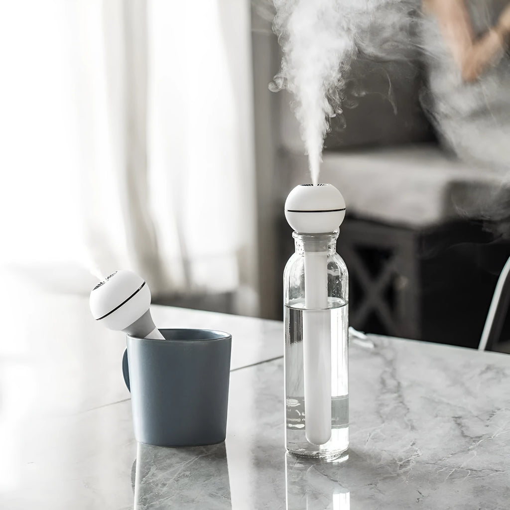 Columnar pink and white magic wand ultrasonic humidifier with USB cable and 1 litre water tank