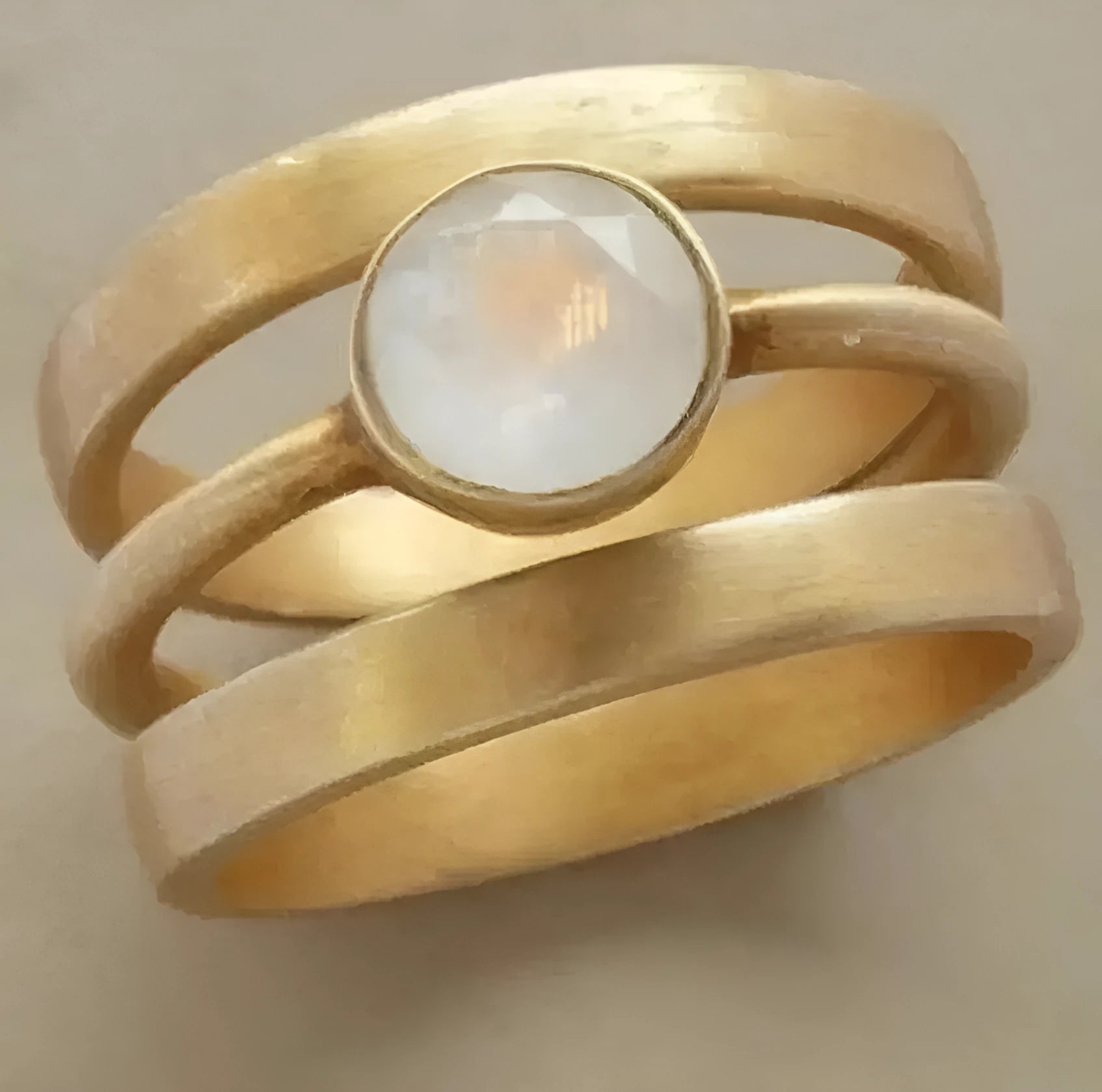 Gold-plated geometric ring with hollow design and a micro-inlaid white chalcedony stone on a titanium steel band.