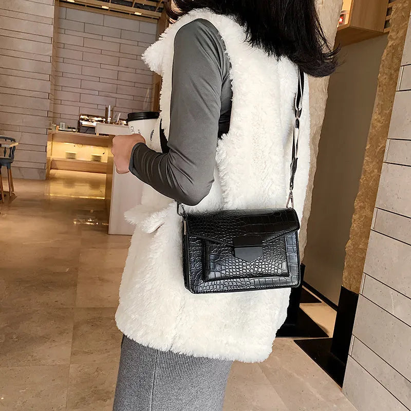 Vintage-style black PU crossbody bag with adjustable strap showing interior