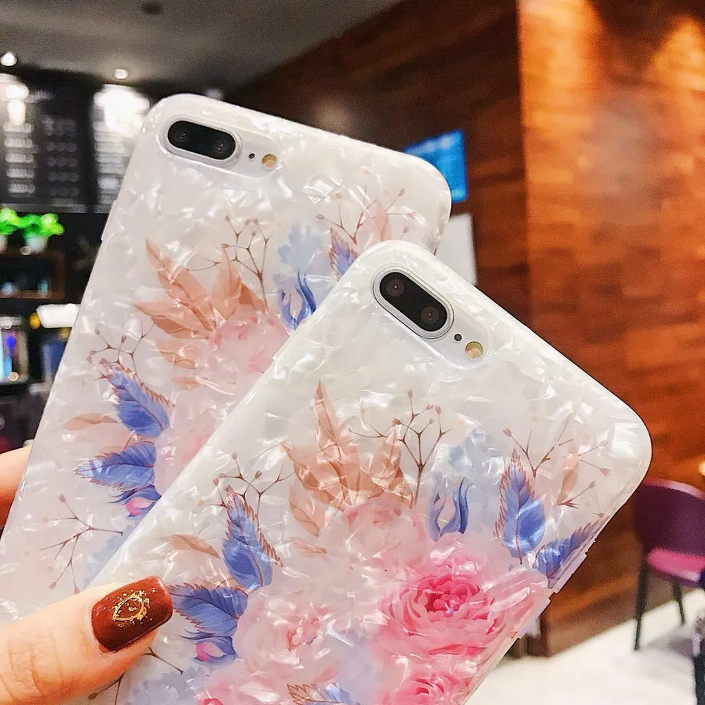 Dream Shell soft TPU iPhone case with rose flower design in purple, shown on a phone.