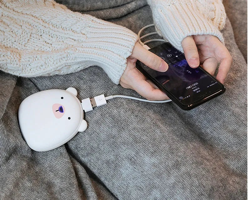 Cute cartoon penguin and polar bear design USB rechargeable hand warmer and power bank unit.