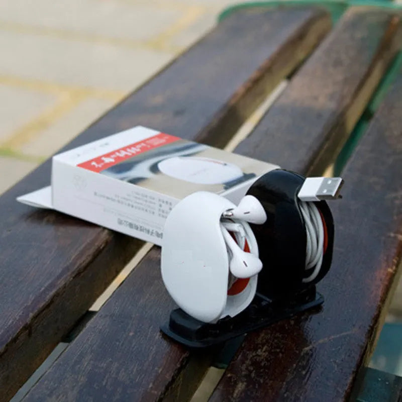 Automatic earphone cable retractor winder in multiple colours on a white background.