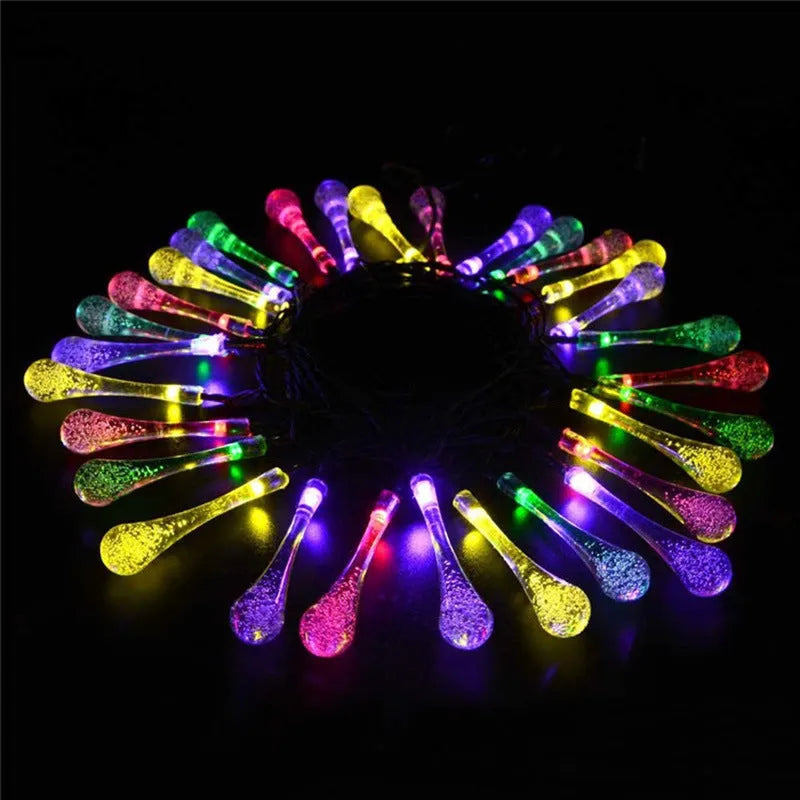 Solar-powered outdoor LED string lights with water drop pendants on 6.5m cable
