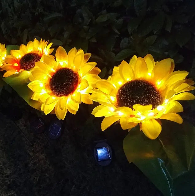 Set of LED solar sunflower garden lights with yellow Bujuan flower heads and stainless steel stems placed along a pathway