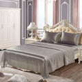 Imitation silk bedding set in grey includes flat sheet, fitted sheet, and two pillowcases