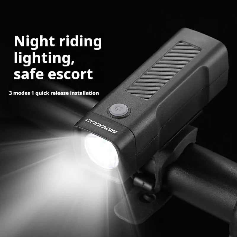 Black bicycle headlight with quick release strap bracket mounted on handlebars