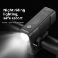 Black bicycle headlight with quick release strap bracket mounted on handlebars