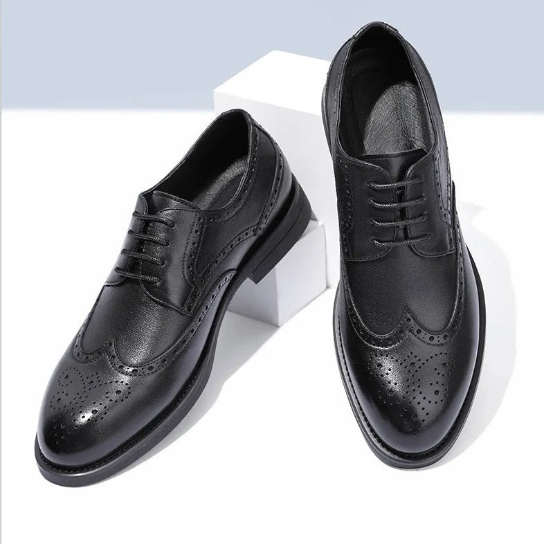 Men's black brogue leather shoes with wingtip perforations and lace-up closure on neutral background