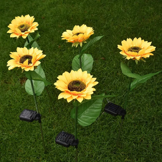 Set of LED solar sunflower garden lights with yellow Bujuan flower heads and stainless steel stems placed along a pathway
