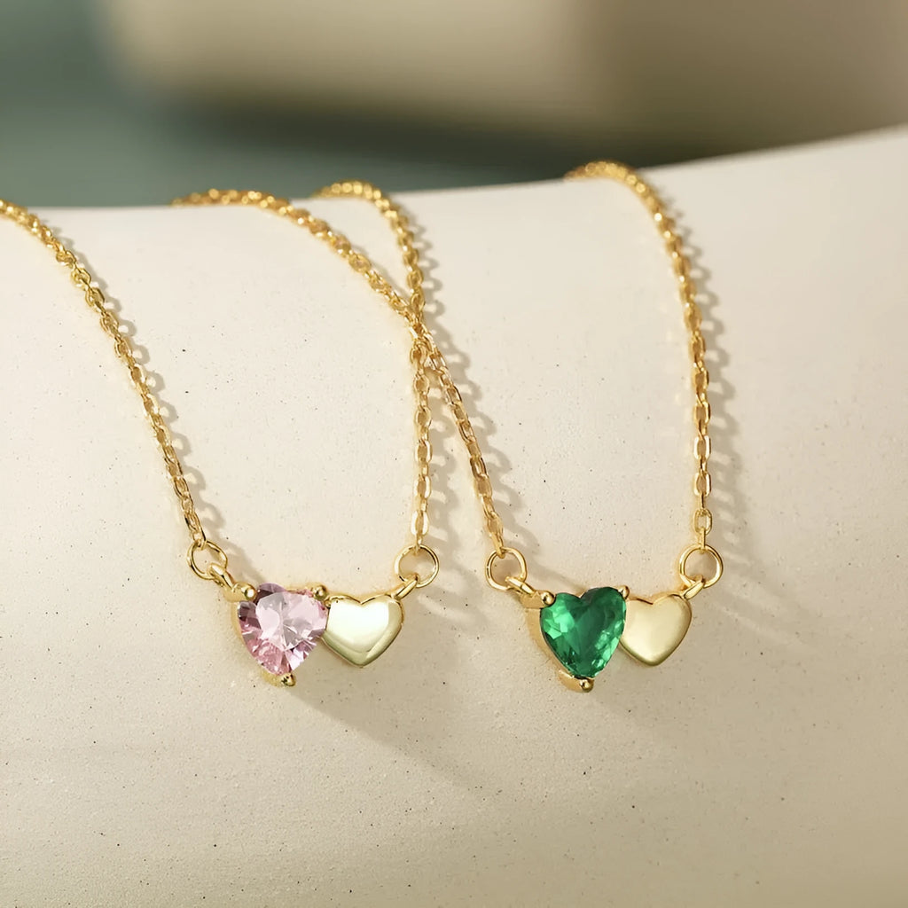 925 silver heart necklace with emerald zircon in gold finish on display