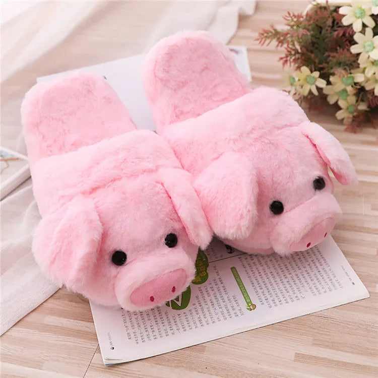 Pink pig-shaped plush indoor slippers with a cute animal face design, shown on a plain background.