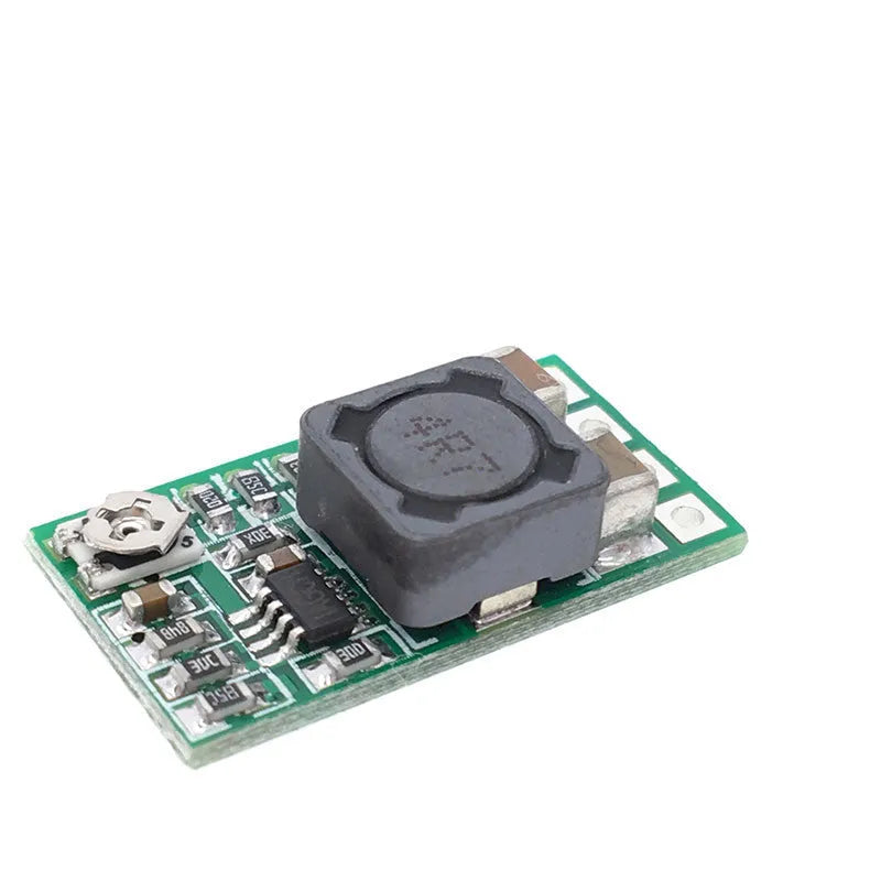 Green mini DC-DC buck converter module stepping 12-24V down to 5V 3A output.