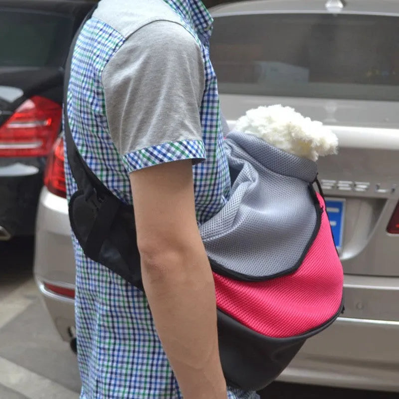 Blue pet backpack carrier for a small dog, showing backpack straps and mesh panel.