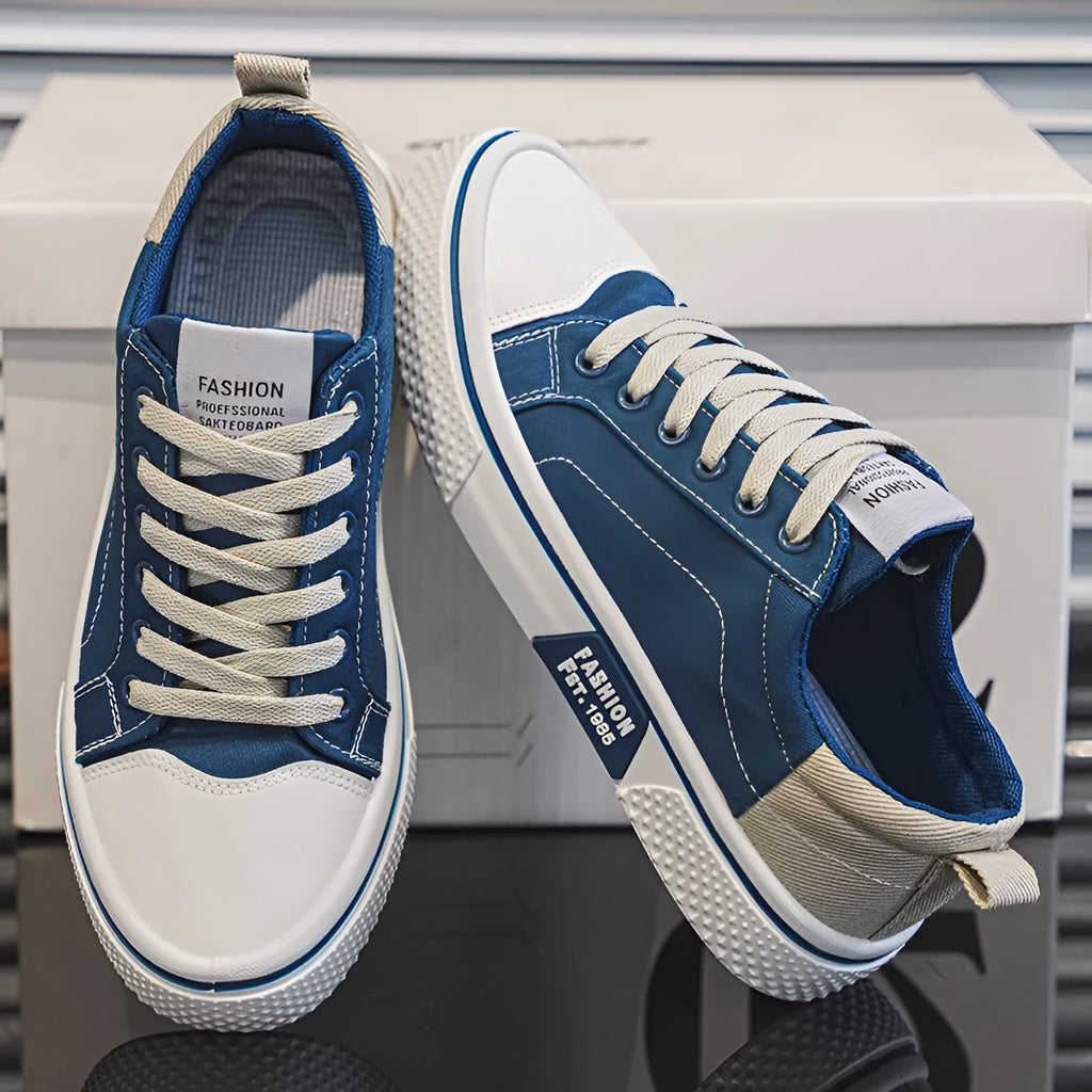 Men's low top casual canvas shoes in blue with round toe and front lace-up, on a plain background.