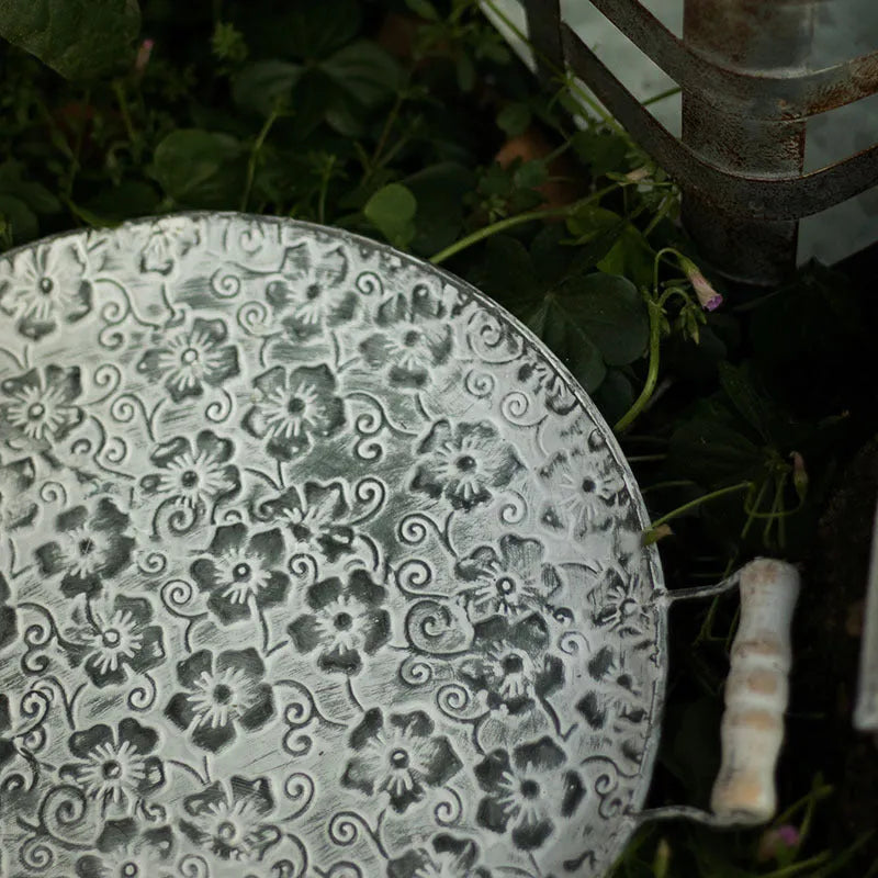 Round wrought iron storage tray in two sizes for organising jewellery or food on a countertop.