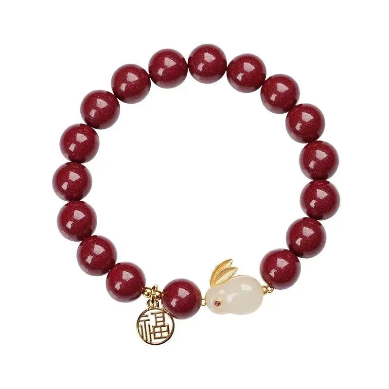 Purple gold sand cinnabar bracelet with jade hare charm in 6mm and 8mm bead sizes.
