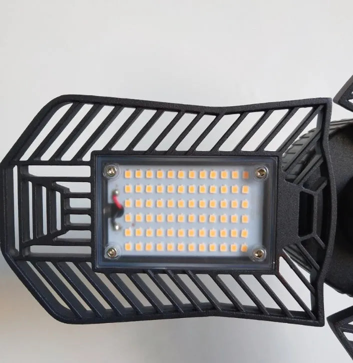 Waterproof industrial foldable garage lamp with aluminium body on a black mounting bracket