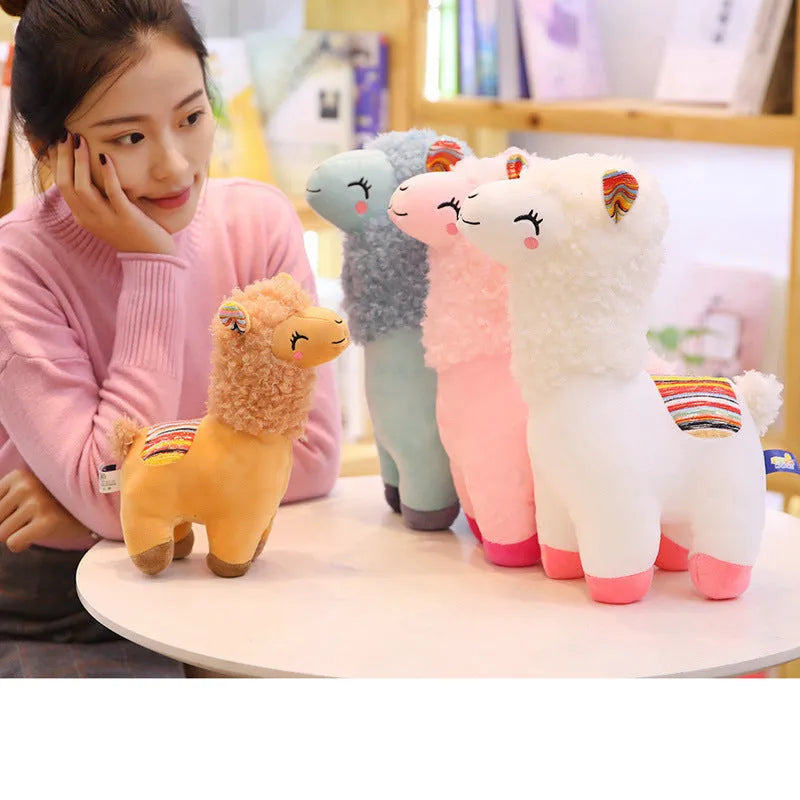 Alpaca llama plush toy in white standing on a surface