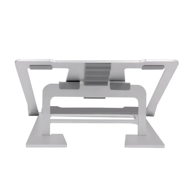 Foldable silver aluminium laptop stand with silicone grips on a desk, showing adjustable angle