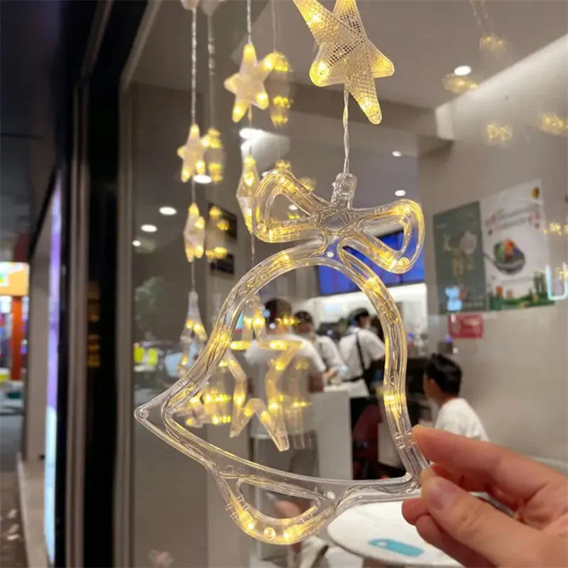 Christmas LED window light with suction cups showing deer, bell, and tree designs
