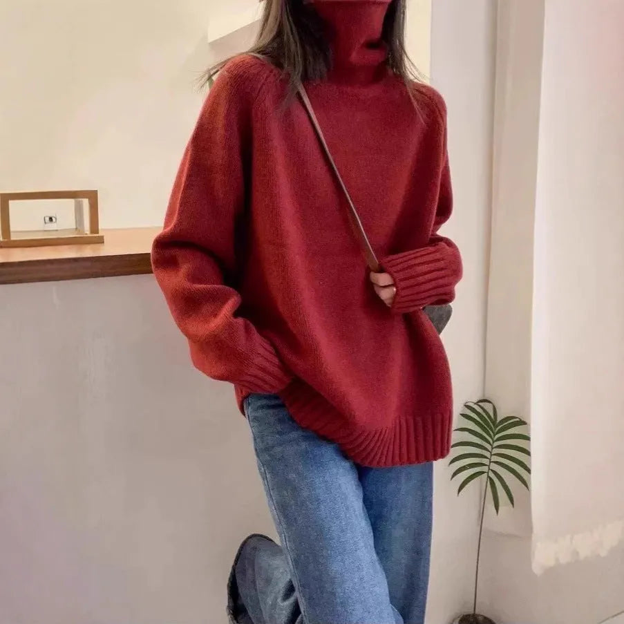 Women's loose grey turtleneck sweater with thick textured pile collar, casual style.