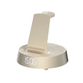 Wireless Bluetooth speaker alarm clock with phone holder in creamy-white colour on a wooden bedside table