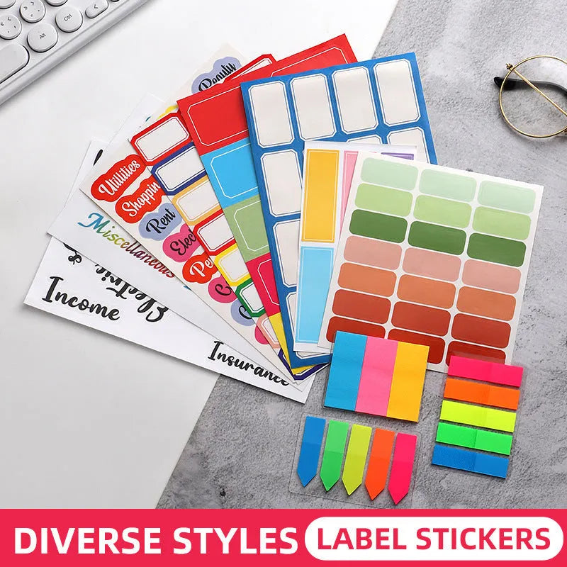 Assortment of handwritten labels, grid stickers, A6 rulers, and coloured sticky notes on a white background.