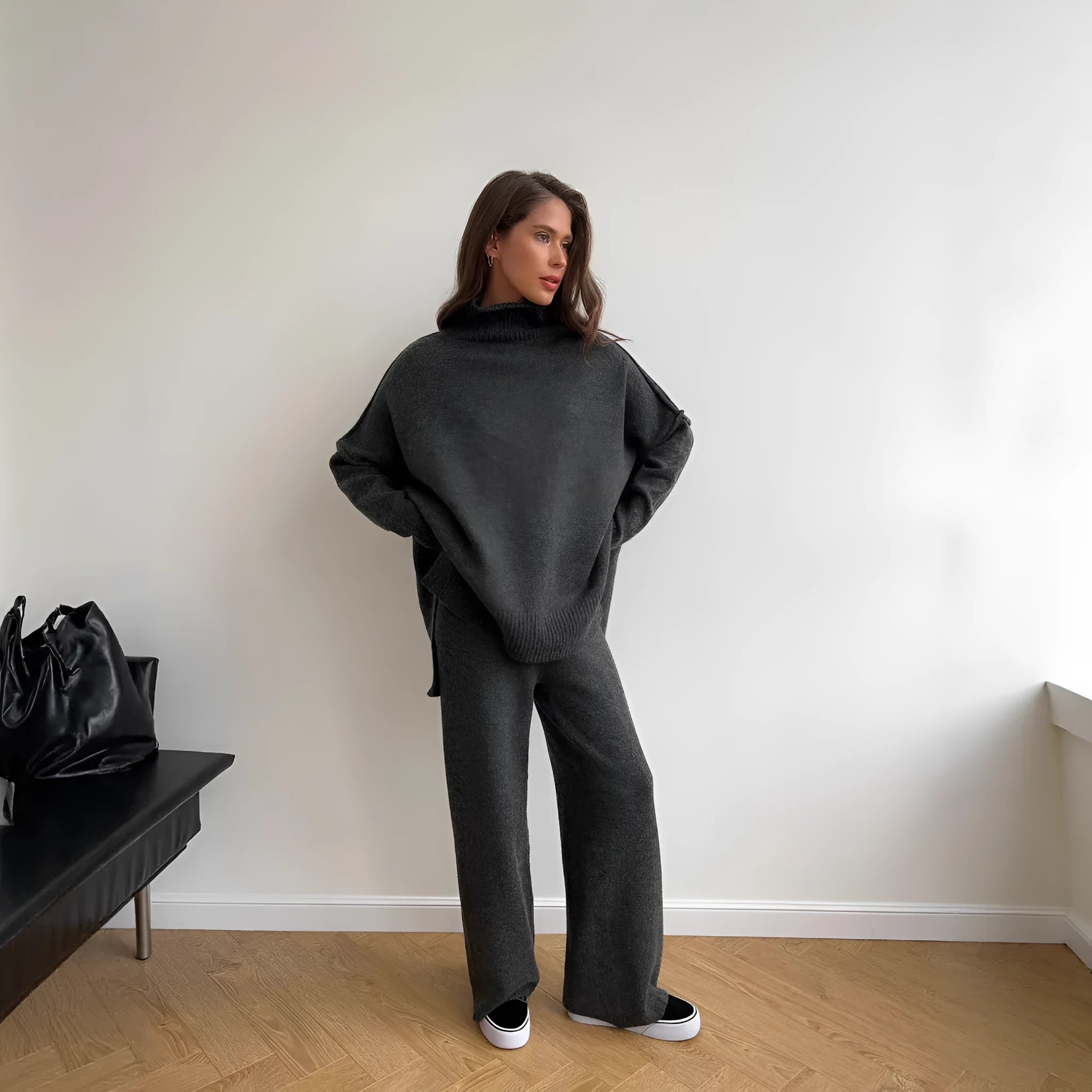 Women's dark grey casual suit with side-slit sweater top and matching trousers.