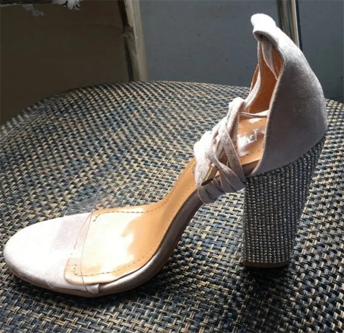 Black and gold pointed-toe plastic high heel shoes for women.