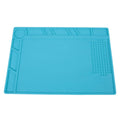 Blue silicone anti-skid watch repair mat lying flat on a workbench.