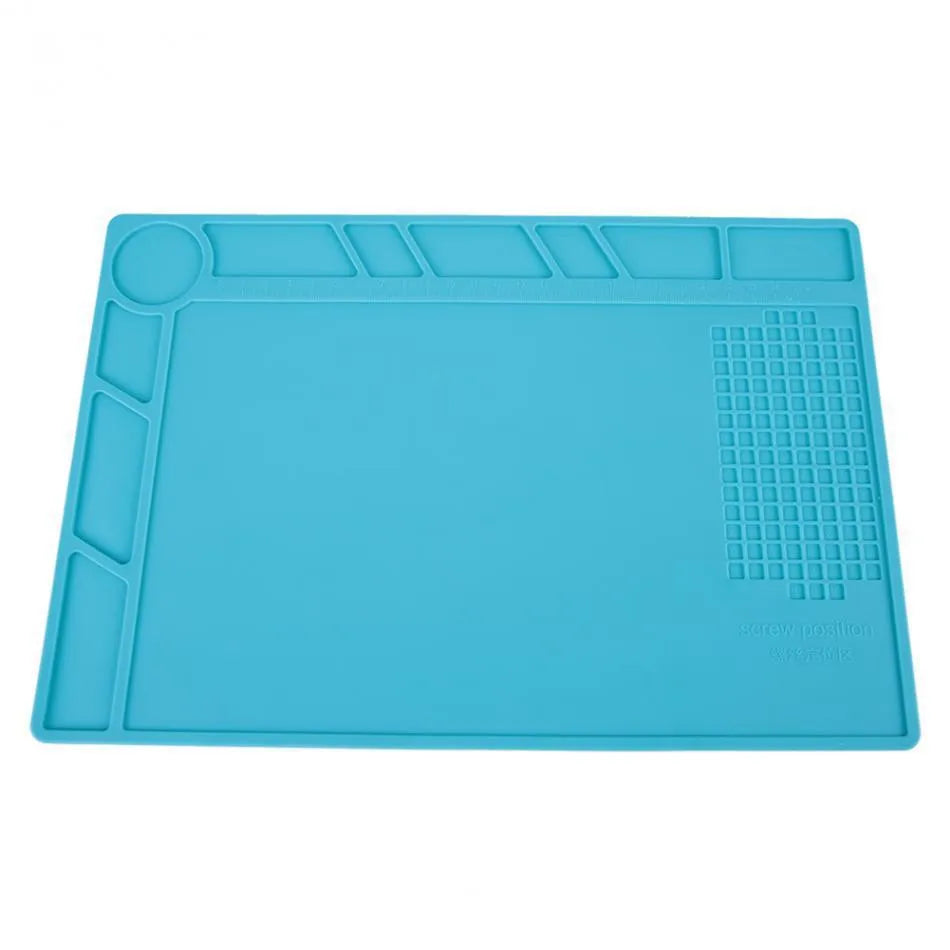 Blue silicone anti-skid watch repair mat lying flat on a workbench.